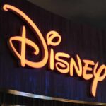 Illuminated Disney logo against a dark background