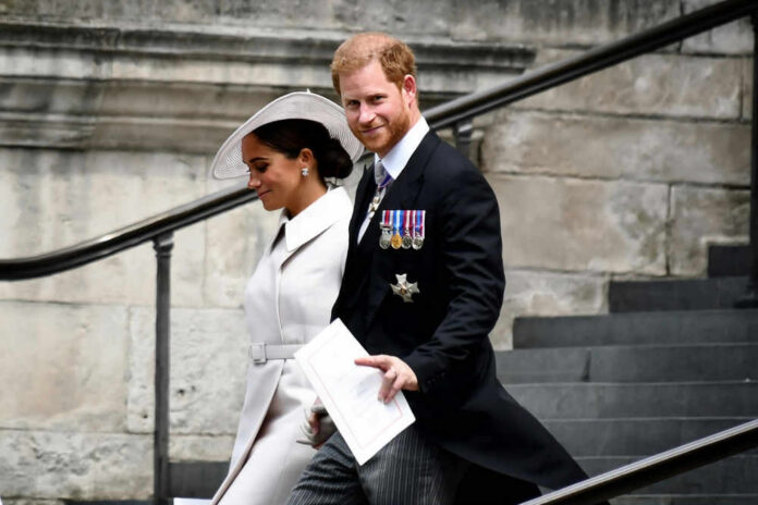 A man and woman walking down outdoor stairs smiling.