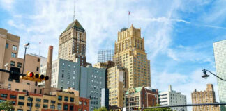 Cityscape with historic high-rise buildings and traffic lights.