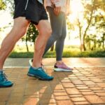Death Risk PLUNGES With Fewer Steps Two individuals walking on a path during sunset