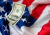 Funflation Hits: Paying More, Playing Less A hundred dollar bill resting on an American flag