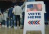 Democrats Abandon Ticket For THIS? People in line next to Vote Here sign