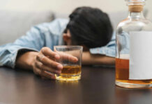 Drinking Plunge Stuns America Person asleep at table holding drink glass