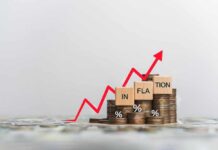 Graph showing inflation trend with coins and wooden blocks