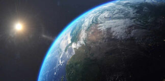Earth from space with sun in background.