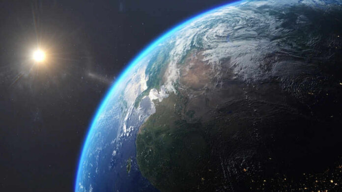 shutterstock_2506345183 Earth from space with sun in background.