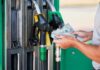 Gas Hike Rekindles 2019 Ghosts Person holding cash at a gas station while preparing to refuel