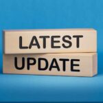 UPDATE: ICE Shooting Sparks Arrest of Officer Wooden blocks with the words latest update on blue background