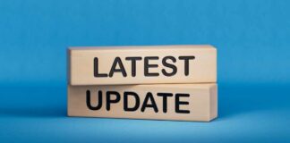 Wooden blocks with the words latest update on blue background
