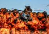 Arson Wave Hits Vacation Paradise? Attack helicopter flying in front of a massive explosion