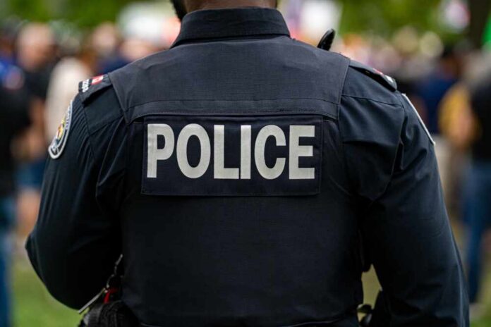 Back,View,Of,Police,Uniform,With,Label. Back view of a police officer wearing a uniform with 'POLICE' displayed