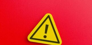 Yellow warning sign with exclamation mark on red background
