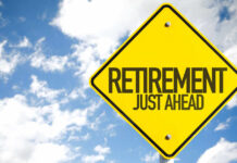 A yellow road sign indicating retirement is just ahead