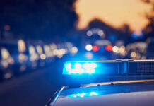 School Outing Turns Deadly police car light bar flashing on a city street at dusk