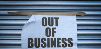 Out of Business sign on closed store shutters.