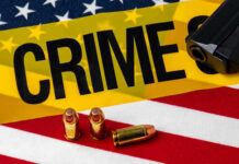 AK-47 Buy Triggers Takedown A gun and bullets on an American flag with a crime scene marker