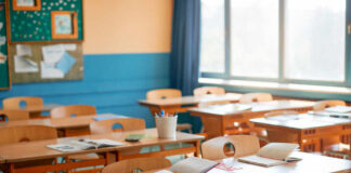 Classroom with wooden desks and open notebooks in natural light