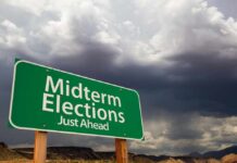 Election Calm, Trump Chaos? green roadside sign against a stormy sky