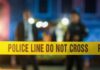VIDEO: Family Massacre Shocks City Police tape at a night scene with blurred officers in the background