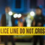 VIDEO: Family Massacre Shocks City Police tape at a night scene with blurred officers in the background