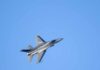 F-16s Scramble Over Trump Rally A commercial airplane flying above two military jets in a clear blue sky
