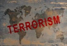 Lawmaker Attack Sparks Terror Probe World map with the word TERRORISM crossed out in red