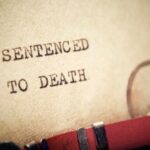 Botched Execution Sparks Chaos Close-up of a typewritten document stating 'SENTENCED TO DEATH'