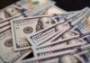Billion-Dollar Promise to American Kids Close-up of scattered hundred dollar bills