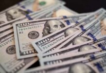 Billion-Dollar Promise to American Kids Close-up of scattered hundred dollar bills