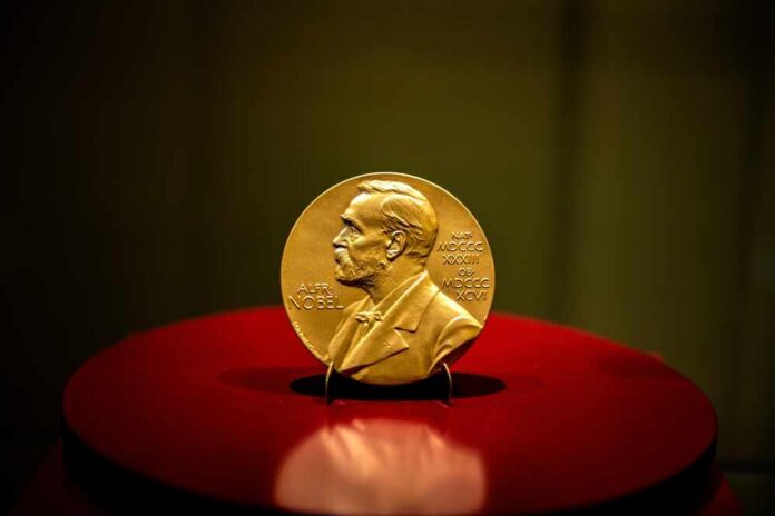 08-05-2021,-,Ankara,-,The,Nobel,Prize,In,Chemistry,Awarded A gold Nobel Prize medal displayed on a red pedestal