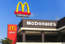 Holiday Bombshell: McDonald’s Goes Wild McDonald's restaurant exterior with drive-thru signs against blue sky
