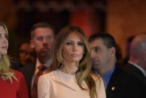 Melania Trump at an event with a crowd in the background