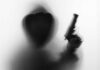 Kids Hit in Shooting Silhouetted hooded figure holding a handgun