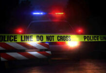 Good Deed, Terrible Outcome – DETAILS Police car with flashing lights behind caution tape.